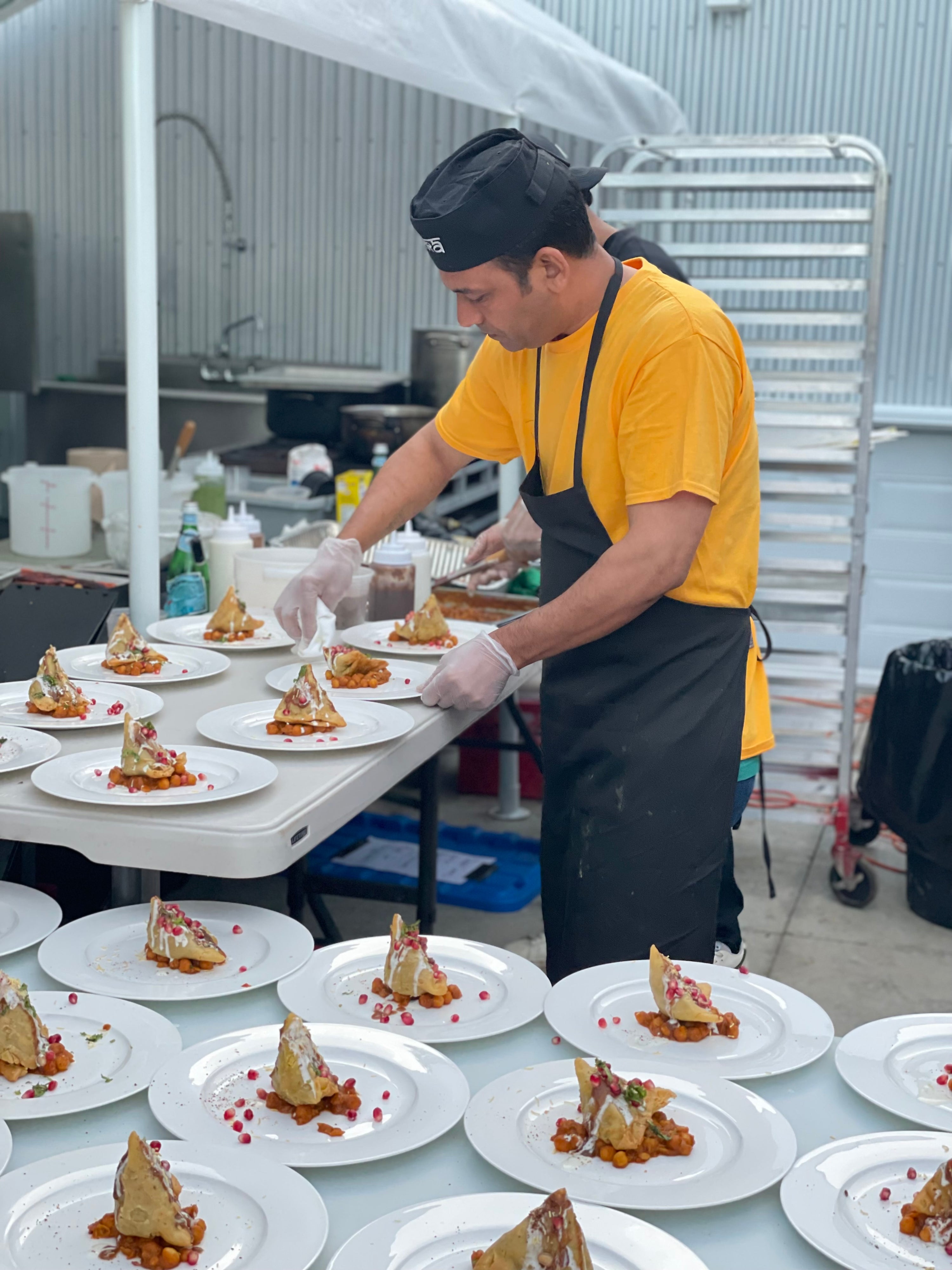 Chef Butola plating sweet potato samosas for event